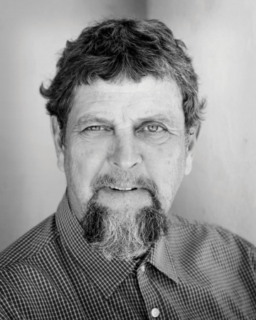 A black and white headshot of Gary Paul Nabhan
