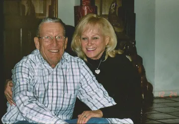 A photograph of Nancy and Craig Berge embracing each other 