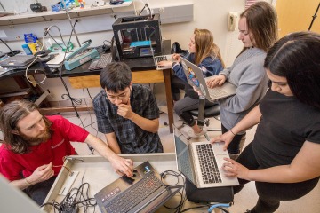 A photograph of engineering students on computers in a makerspace