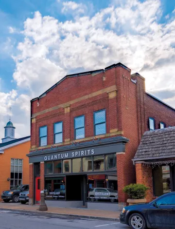 A photograph of the outdoor area of red-brick building of Quantum Spirits
