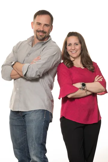 A photograph of Shalane Simmons and Devin Simmons, with their arms crossed, back-to-back