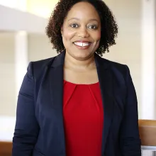 Tammi Walker headshot, smiling African American woman wearing red shirt and blue jacket