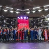 a group of people gathers on a stage at a graduation ceremony