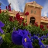 old main rising over a bed of flowers