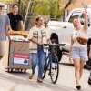 a group of people walking with their belongings into a building